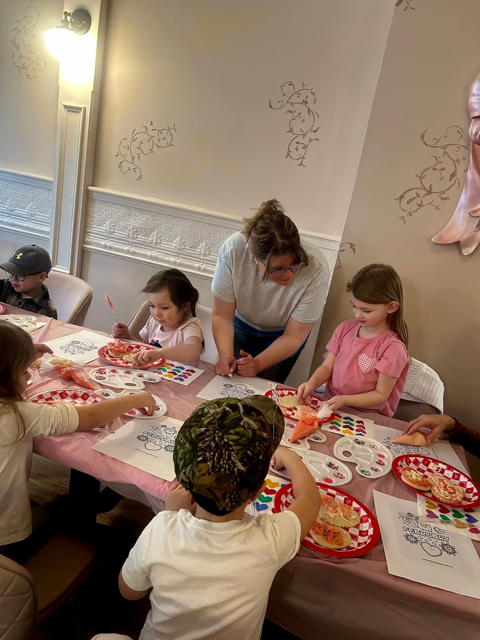Children decorating cookies together at Kay & Rose